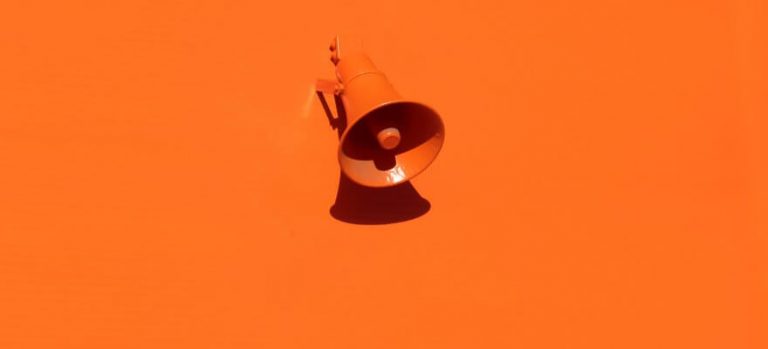 orange megaphone on orange wall