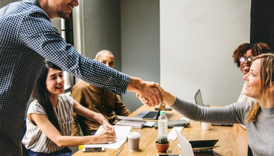 Two employees shaking hands