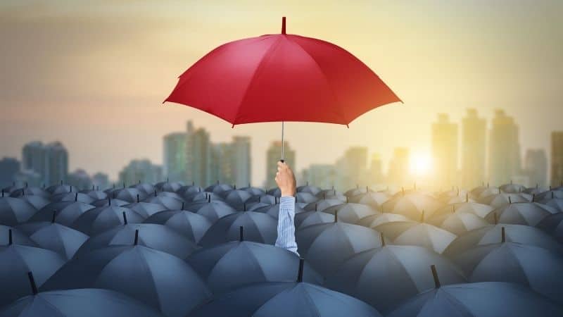 The only red umbrella in a sea of umbrellas.