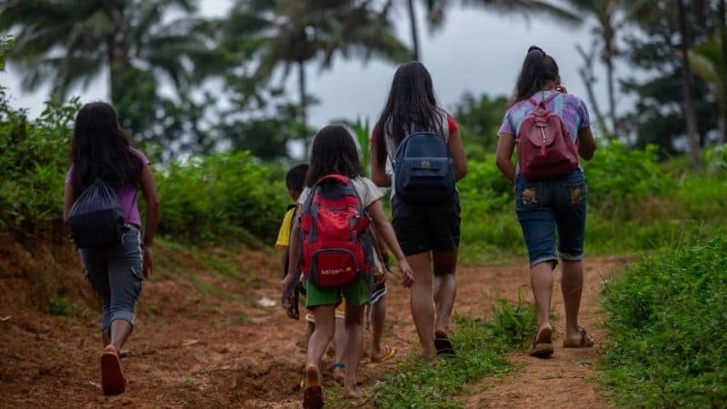 The real Filipino time. Filipino children walk to school even before the sun rises.