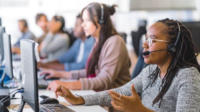 Team building is important because it improves better customer service. The photo shows women answering calls in a call center.