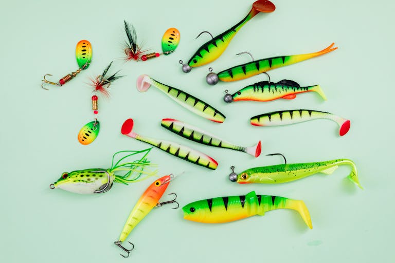 A vibrant collection of fishing lures on a light green surface, ideal for hobbyists.